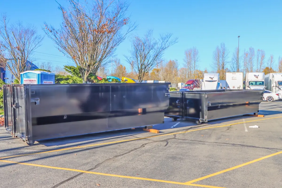 Professional dumpster rental service with roll-off container on residential driveway in Bellevue